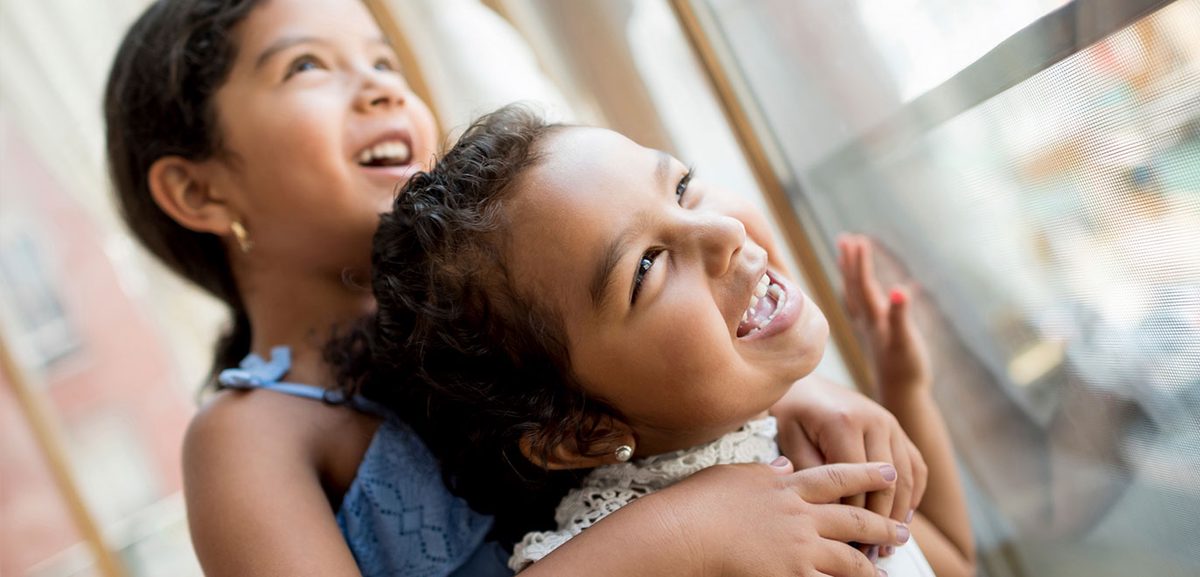 Two young girls smiling