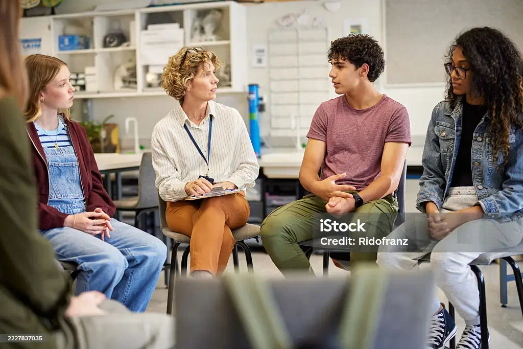 Staff in a group discussion in a classroom