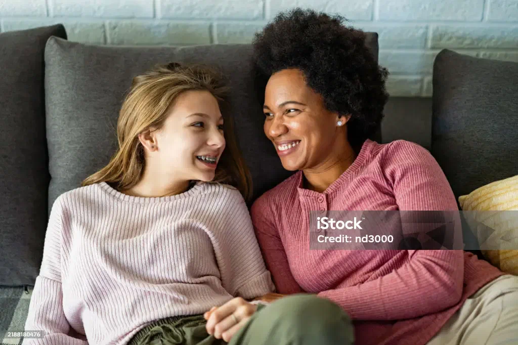A foster mother embracing her teenage daughter