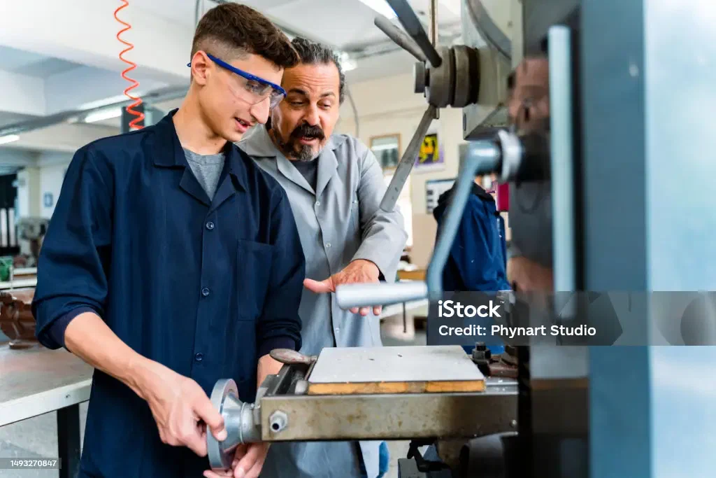 A teenager in a vocational classroom with a teacher